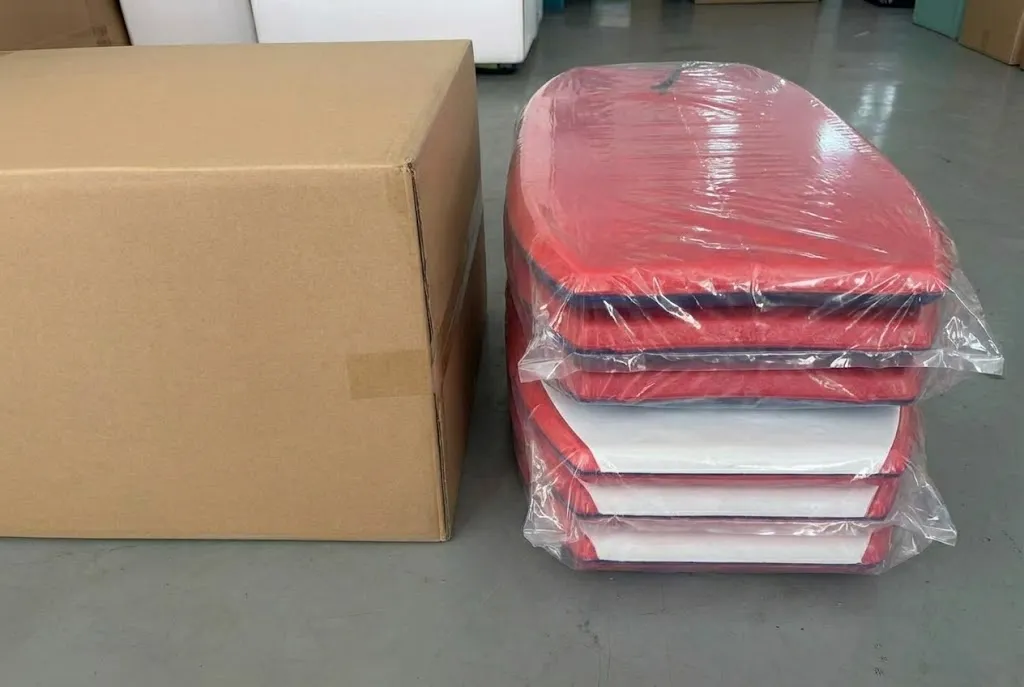 Comparison of polybag nesting versus rigid carton packing for wholesale bodyboard shipping.