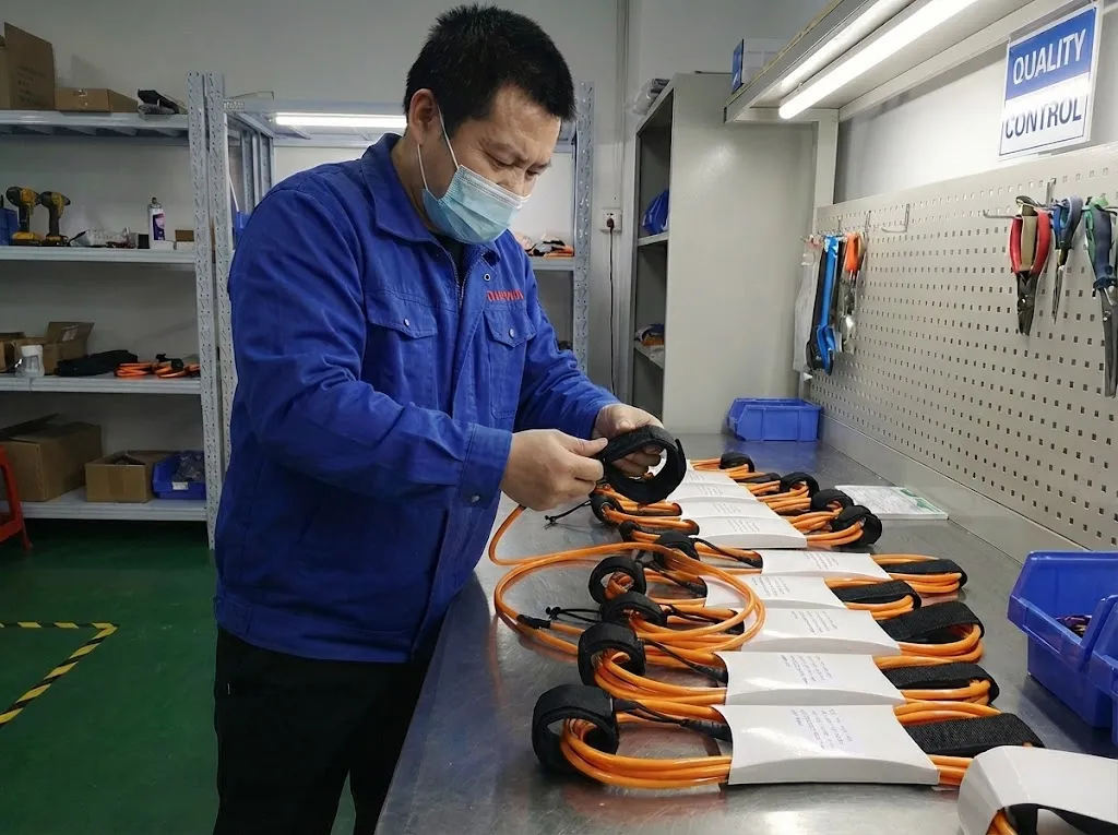 Leash Assembly Inspection Worker inspecting assembled surf leashes at a production table