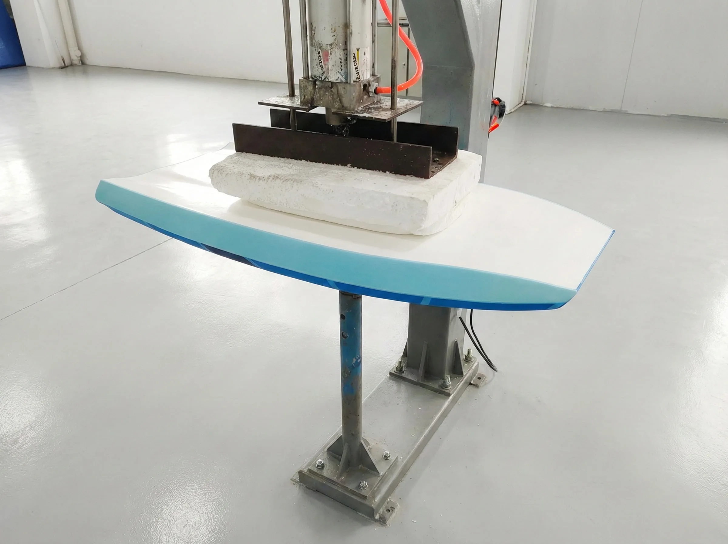 Senior factory workers performing precision hand-finishing on XPE bodyboard rails